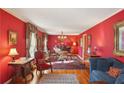 Bright red living room with elegant furniture, hardwood floors and decor at 1566 Arden Sw Dr, Marietta, GA 30008