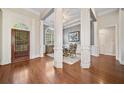 Grand foyer with hardwood floors, decorative columns, and arched doorway offering a luxurious entrance at 2121 Whitekirk Nw St, Kennesaw, GA 30152