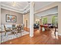 Elegant living room with hardwood floors, large windows, a dining area, and a pool table for entertaining guests at 2121 Whitekirk Nw St, Kennesaw, GA 30152