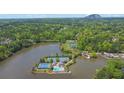 Aerial view of community amenities: lake, tennis courts, swimming pool, and lush greenery at 7037 Waters Edge Dr, Stone Mountain, GA 30087