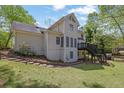 Spacious backyard featuring a patio and stairs, with natural landscaping and room for outdoor activities at 7037 Waters Edge Dr, Stone Mountain, GA 30087