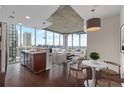 Bright, open living space with hardwood floors, city views, and modern kitchen island at 855 Peachtree Ne St # 2403, Atlanta, GA 30308