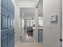 Inviting entryway with a blue front door and a view into the living room with wood floors and neutral decor at 400 17Th Nw St # 2218, Atlanta, GA 30363