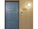 Blue front door with unit number 2218 and a lit lightbulb for added security at night at 400 17Th Nw St # 2218, Atlanta, GA 30363