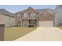 Beautiful two-story brick home with a well-kept lawn and attached two-car garage at 4349 Sublime Trl, Atlanta, GA 30349