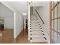 Bright entryway featuring hardwood floors and stairs leading to the upper level at 6580 Scott Valley Rd, Sandy Springs, GA 30328