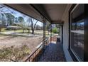 View from the front porch featuring decorative iron railings and neighborhood view at 6727 Kull Dr, Lithia Springs, GA 30122