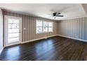 Bright living room featuring hardwood floors, a ceiling fan, and natural light at 6727 Kull Dr, Lithia Springs, GA 30122