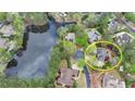 Overhead view showcasing the property, nearby lake, neighboring houses, and lush greenery at 803 Amerden Ponds Ct, Johns Creek, GA 30097