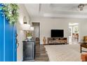 Welcoming foyer with hardwood floors leading to a spacious living room featuring a stylish rug and entertainment center at 263 Keller Dr, Mcdonough, GA 30252
