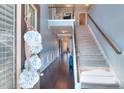 Elegant home entryway showcasing staircase, dark wood floors, and upper level landing at 910 Shannon Mist Dr, Loganville, GA 30052