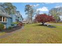 Home exterior and landscape with mature trees, mulch ground cover, and green grass at 2735 Peachtree Walk, Duluth, GA 30096