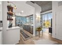 Open-concept kitchen with stainless steel appliances, white countertops, and large windows showcasing city views at 923 Peachtree Ne St # 939, Atlanta, GA 30309
