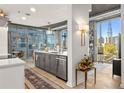 Kitchen featuring modern cabinetry, stainless steel appliances, and expansive windows with city views at 923 Peachtree Ne St # 939, Atlanta, GA 30309