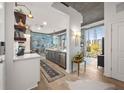 Modern kitchen with stainless steel appliances, island seating, and cityscape views from large windows at 923 Peachtree Ne St # 939, Atlanta, GA 30309