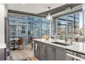 Kitchen island with stainless steel appliances and city views in a modern condo at 923 Peachtree Ne St # 939, Atlanta, GA 30309