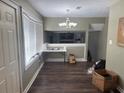 An open-plan living area with hardwood floors and neutral-colored walls and a decorative chandelier at 2943 E Howell Dr, Lawrenceville, GA 30044