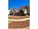 Well-maintained house with lush landscaping, a driveway, and a charming curb appeal at 779 Harvest Brook Dr, Lawrenceville, GA 30043