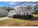 Inviting one-story home with a well-manicured lawn and attached two-car garage at 4419 White Rd, Douglasville, GA 30135