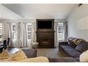 Comfortable living room featuring a fireplace, large TV, and neutral décor at 4419 White Rd, Douglasville, GA 30135