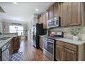 Kitchen features dark wood cabinets, stainless steel appliances, granite counters, and hardwood floors at 115 Dorys Way, Dallas, GA 30157
