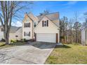 Two-story home featuring an attached garage, driveway, and manicured lawn at 1196 Yellow River Dr, Lawrenceville, GA 30043