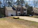 Two-story home with brick accents, a two-car garage, and a spacious front yard, partially renovated at 645 Legend Sw Ct, Atlanta, GA 30331