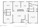 First floor plan featuring the primary bedroom, living room, dining room, and kitchen at 10670 Day Lily Dr, Hampton, GA 30228