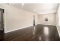 Open living room featuring beautiful hardwood floors, neutral walls, and recessed lighting at 1207 Ellington Dr, Morrow, GA 30260
