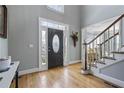 Inviting foyer with hardwood floors and a staircase leading to the upper level at 10660 Thatcher Way, Johns Creek, GA 30097