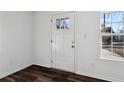 Bright entryway with a new white door, a window and stylish dark laminate flooring at 4378 Glenwood Pkwy, Decatur, GA 30032