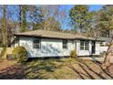 A charming one-story home with a clean white exterior and lush greenery surrounding the property at 4378 Glenwood Pkwy, Decatur, GA 30032