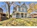 Lovely blue two-story house featuring a large front porch, balcony, and lush lawn at 561 Culberson Sw St, Atlanta, GA 30310