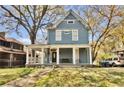 Inviting two-story home with a spacious porch and a well-manicured front lawn at 561 Culberson Sw St, Atlanta, GA 30310