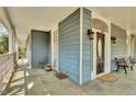 Spacious front porch featuring stylish slate tile flooring, a seating area, and charming decor at 561 Culberson Sw St, Atlanta, GA 30310