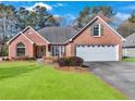 Charming single-story brick home with a well-manicured lawn and attached two car garage at 1050 Sunny Field Ct, Lawrenceville, GA 30043