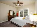 Cozy bedroom with ceiling fan, natural light, and neutral decor at 1560 Baygreen Rd, Suwanee, GA 30024
