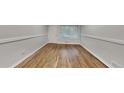 Bright living room with newly refinished hardwood floors and neutral paint at 1735 W Austin Rd, Decatur, GA 30032