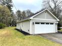 Exterior view of a home featuring a two-car garage and well-manicured lawn at 3503 Saddlebrook Dr, Loganville, GA 30052