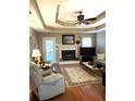 Cozy living room with a fireplace and trey ceiling at 3503 Saddlebrook Dr, Loganville, GA 30052