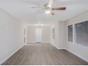 Bright living room with gray vinyl plank flooring, ceiling fan, and natural light from two windows at 864 Northview Dr, Forest Park, GA 30297