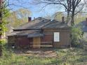 Back exterior of home with overgrown yard at 707 Dill Sw Ave, Atlanta, GA 30310