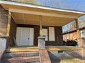 New wood porch with brick and grey stone supports with front door at 707 Dill Sw Ave, Atlanta, GA 30310