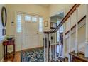 Welcoming foyer with hardwood floors, a staircase, and a view into other rooms at 802 Sugar Creek Se Dr, Conyers, GA 30094
