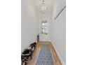 A well-lit entryway offers storage for shoes and coats, leading into the home with stylish light fixtures at 2120 Sonoma Se Dr, Smyrna, GA 30080