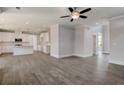 Open-concept living space with hardwood floors, recessed lighting, and a seamless flow into the kitchen at 3298 Rangers Gate, Marietta, GA 30062