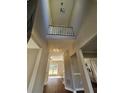 Bright foyer with hardwood floors, high ceilings, and a view of the staircase and hallway at 79 Dogwood Ferry Ct, Lawrenceville, GA 30046