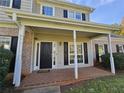 Inviting front porch with brick detail, white columns, and a classic black front door and black shutters at 79 Dogwood Ferry Ct, Lawrenceville, GA 30046
