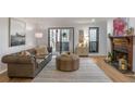 Cozy living room showcasing a fireplace and sliding glass doors to balcony at 210 Woodcliff Dr, Atlanta, GA 30350