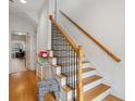Elegant staircase with wooden rails, white risers and decorative black metal spindles at 1186 Arbor Park Sw Ln, Atlanta, GA 30311